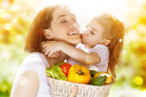 happy family keeps fresh vegetables