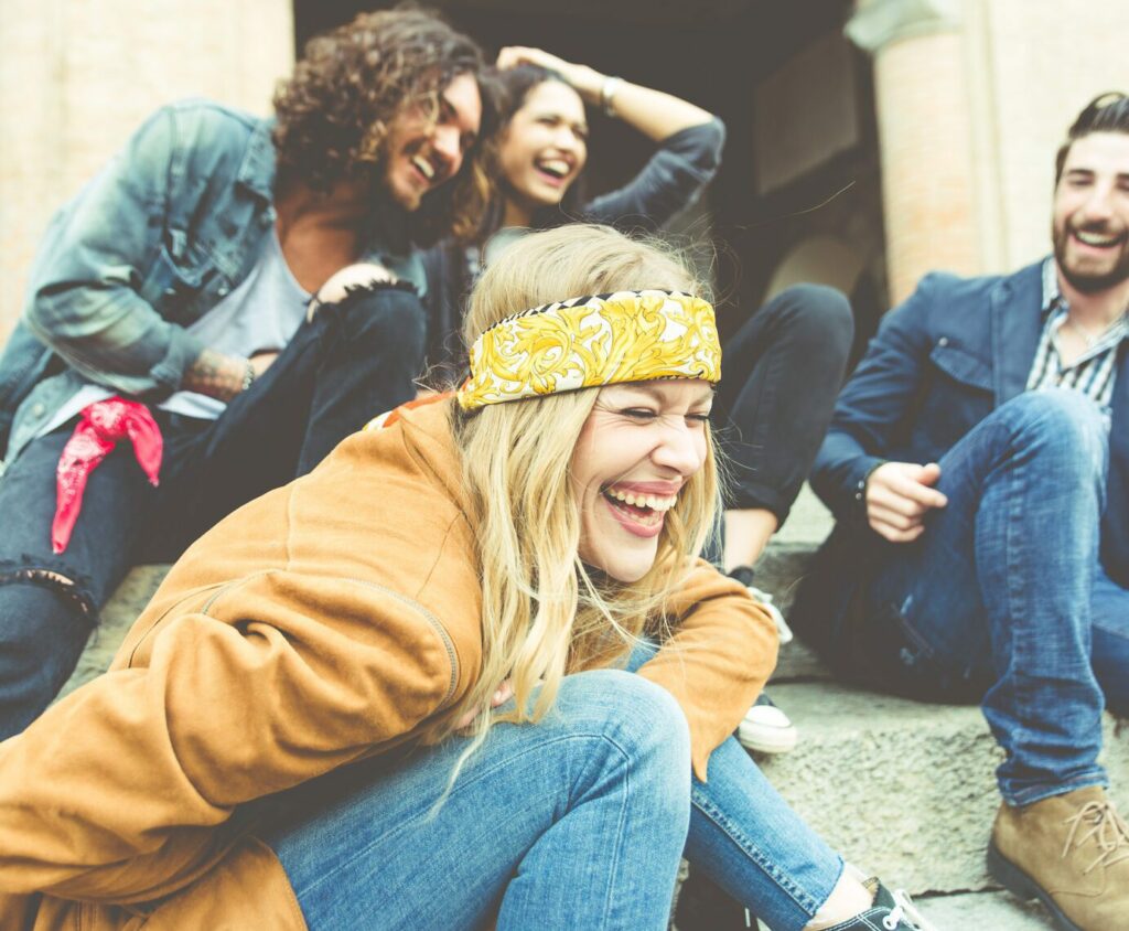 Group Of Four Friends Laughing Out Loud Outdoor, Sharing Good An