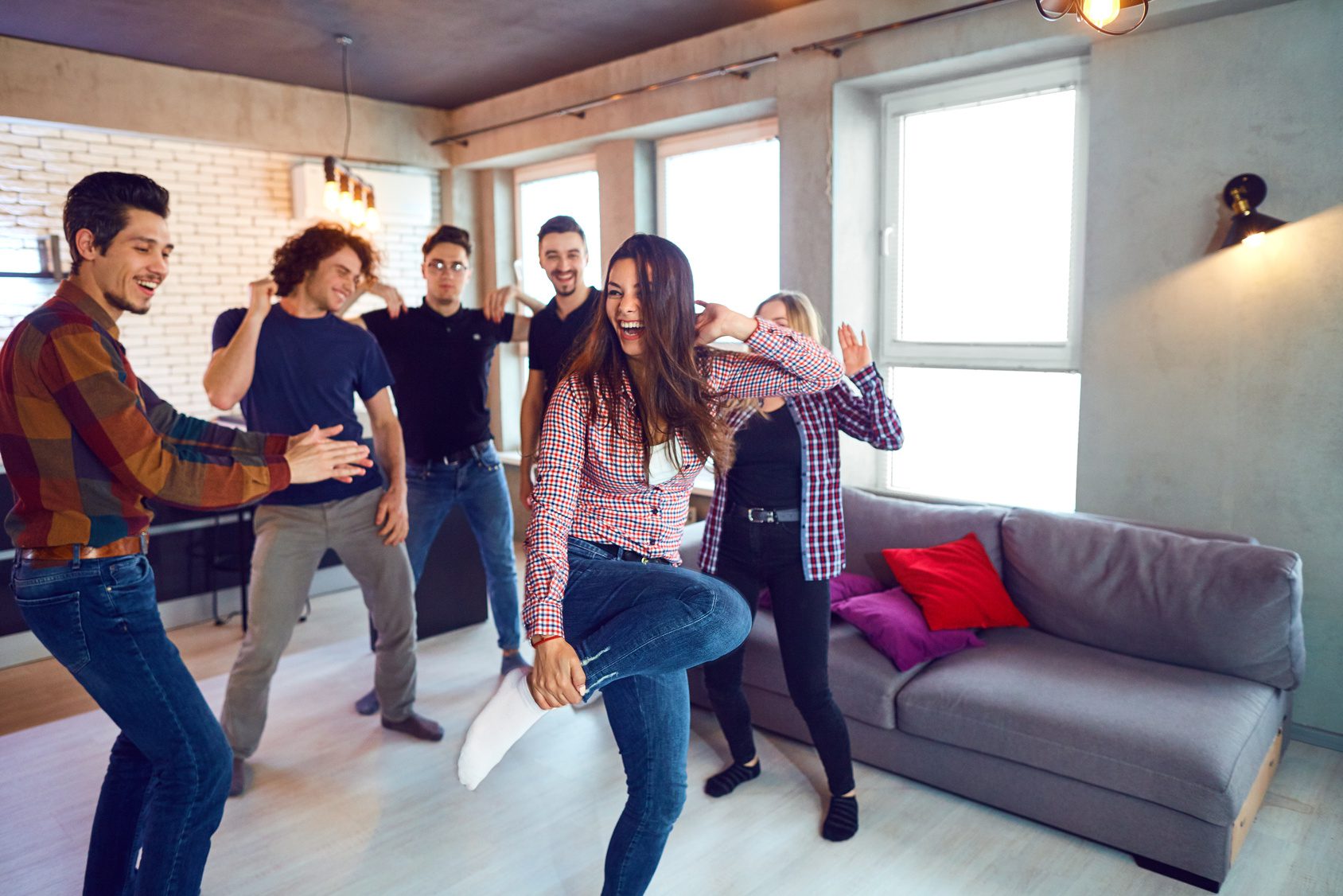 Friends dance fun at a student’s party in the apartment